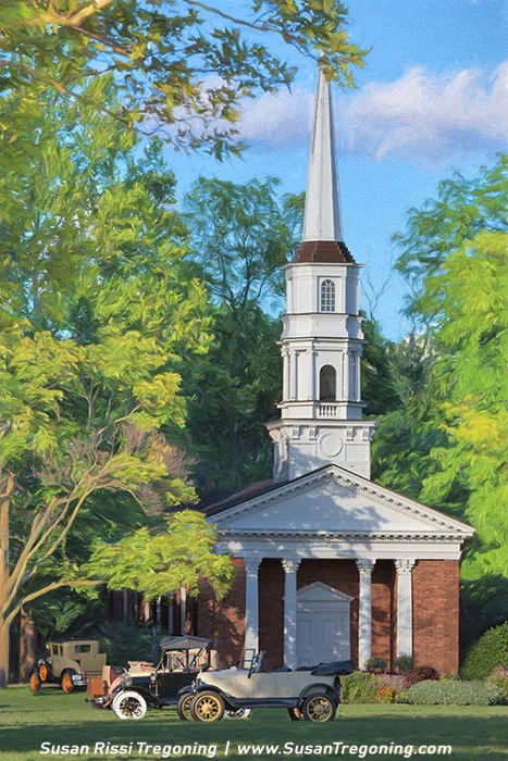A red‑brick church with a tall white steeple rises above lush green trees under a bright blue sky with scattered clouds. White columns frame the front entrance, and two vintage automobiles are parked along the street in front of the building, creating a nostalgic early‑20th‑century atmosphere.