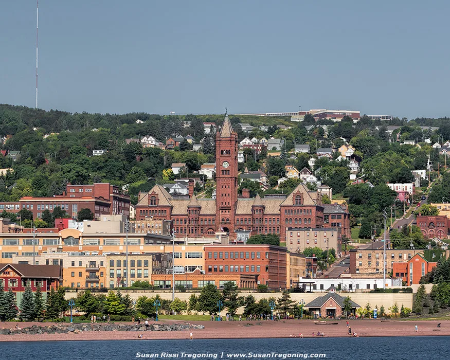 Duluth’s Old Central High School was built in 1892 of locally mined sandstone. Overlooking the Duluth harbor, it dominates the cityscape towering over the city’s business district. At $460,000, it was one of the most costly public works projects of the era. It was designed by local Duluth architects who borrowed from some of the best in eclectic Richardsonian Romanesque design to give the city a school to rival even the master, Henry Richardson’s own work. It features a 230 foot clock tower that was patterned after Big Ben in London. They didn’t miss a detail, from smiling cherubs and grotesque animal figures over the cavernous entrance to the towering clock tower. It’s simply amazing! In 1972, it ceased to be the Central High School but it is still in use by the school district.