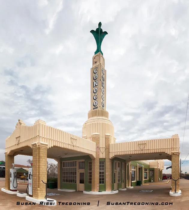 The iconic Conoco Tower Station in Shamrock, Texas, featuring its tall Art Deco tower with “CONOCO” spelled vertically and cream‑and‑green geometric detailing across the restored service station complex.