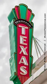 The neon sign for the Shamrock Texas Theater in Shamrock, Texas, featuring its tall vertical design and classic retro lettering.