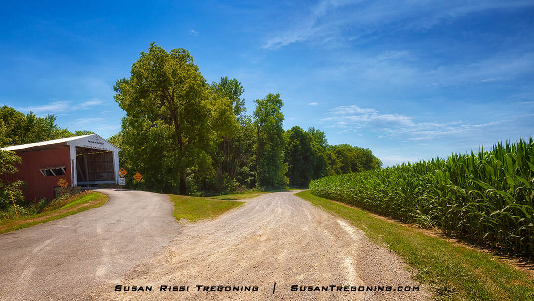 Crooks Covered Bridge spans Little Raccoon Creek. It sits on a small hill overlooking a scenic country road and cornfields in Parke County, Indiana.