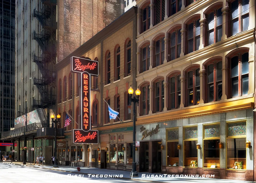 Exterior of the Berghoff Restaurant in the Chicago Loop with its vertical sign on a historic building and surrounding downtown streetscape.