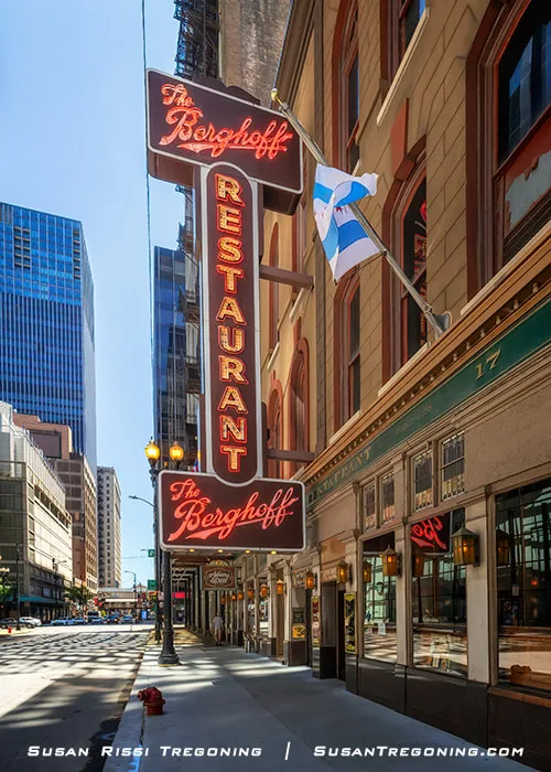 Tall vertical neon sign on the exterior of the Berghoff Restaurant’s historic building in the Chicago Loop.