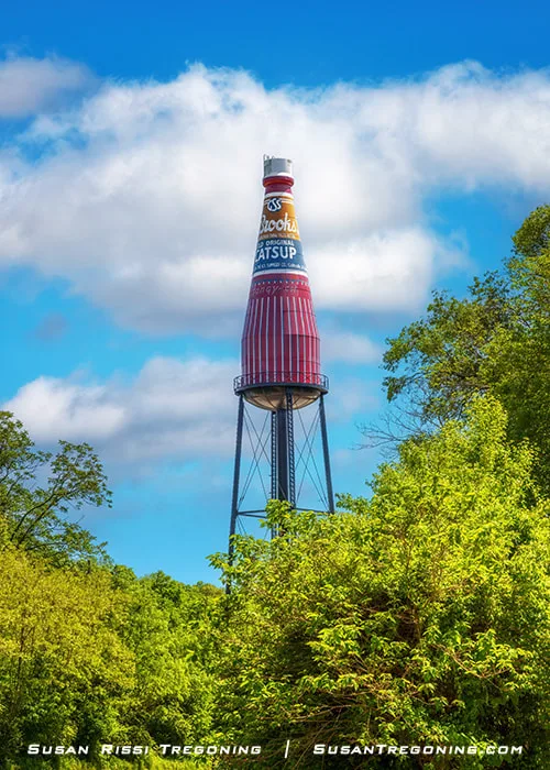 The world’s largest catsup bottle water tower is shown in Collinsville, Illinois. The tall structure is painted like a Brooks catsup bottle and marks the site where the Brooks catsup factory once operated along Route 66.
