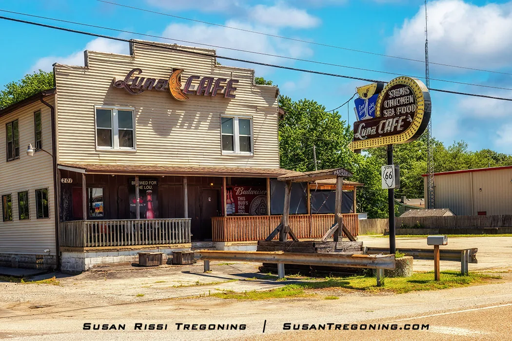 The exterior of the Luna Café in Mitchell, Illinois, is shown. The building dates to 1924, predating Route 66 by two years. It operated as a bar that became a restaurant during Prohibition and remains open today, though it no longer serves food.