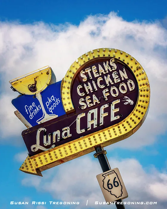 A close‑up view of the historic neon sign shows a curved arrow and a martini glass with a red cherry. The cherry was a subtle code that, when lit, indicated “entertainment” was being offered for the evening according to local legend.