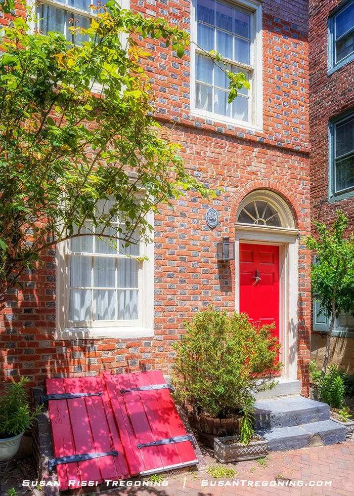 A Georgian‑style brick residence on Elfreths Alley in Philadelphia, showing a symmetrical façade with evenly spaced windows and a central entryway along the historic street.