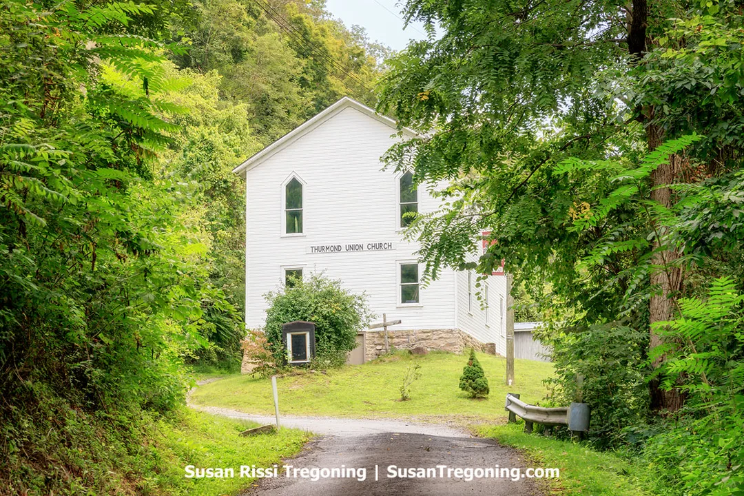  The Thurmond Union Church, built around 1927 on the mountainside above the Thurmond Railroad Depot, shown as a two‑level structure resting on the foundation of an earlier church. The building has a front entrance with a bell tower not visible from the road, with Sunday School rooms on the first floor and the sanctuary on the second.