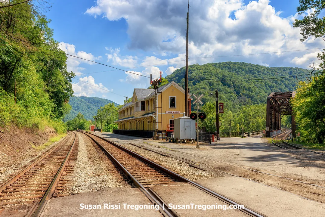 The Thurmond Train Depot is located at the New River's edge, in the Y, between where the railroad tracks merge. The station is positioned directly in front of the bustling mainline, while the nearby spur line follows Dunloup Creek on the right side. The spur utilizes the Southside Junction Railroad Bridge to connect with the mainline and shares the crossing over the New River with a one-lane automobile bridge. The bridge is one of Thurmond’s most important historic features since it was the construction of the bridge across the New River that officially established Thurmond as a town.