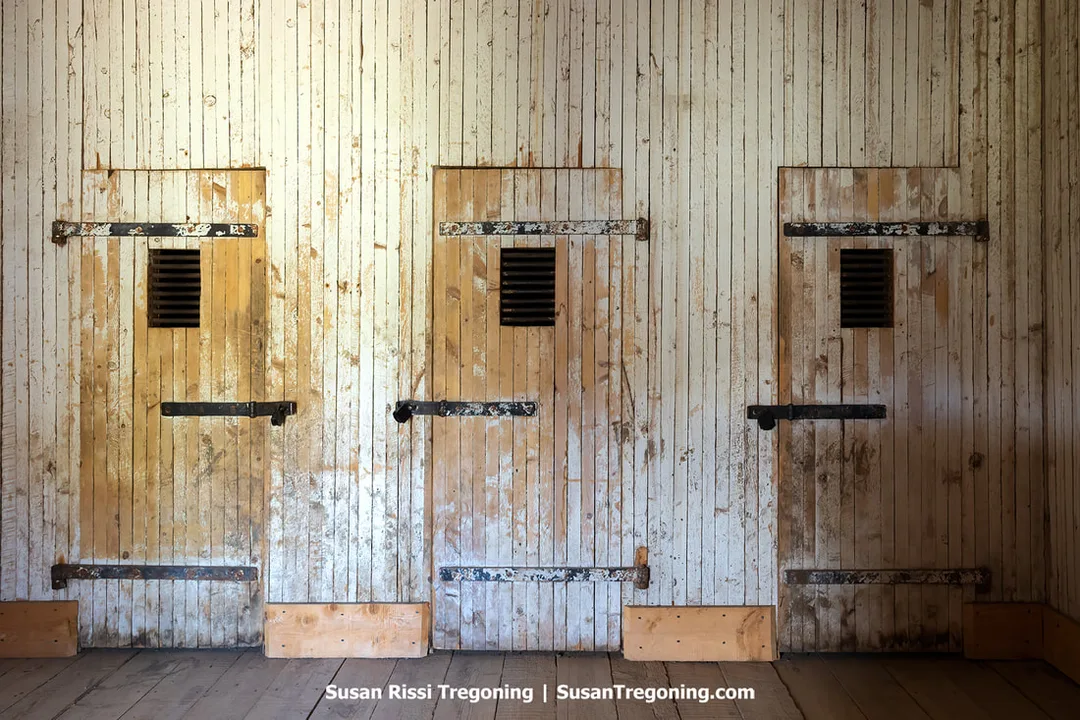 Interior view of the Sweetwater County Jail in South Pass City, with small, dark rooms built of stone or wood and minimal features visible. The preserved space reflects the building’s original 1870 function as Wyoming’s oldest jail.
