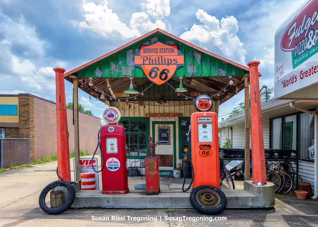 Mahan’s Filling Station on Route 66 in Springfield, Illinois, stands beside Fulgenzi’s Pizza and Pasta. The small structure is recognized as the oldest gas station in the state, with its restored exterior visible along the roadside.