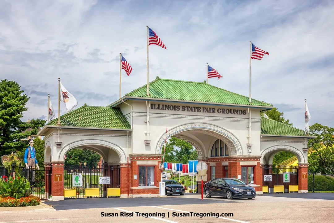 The historic 1910 main gate at the Illinois State Fairgrounds in Springfield, Illinois, stands along Route 66. Behind the gate is the Abe Lincoln Rail Splitter statue, positioned within the fairgrounds. The Illinois State Fairgrounds are the only fairgrounds located on Route 66.