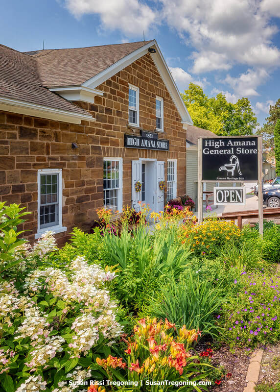 A vibrant explosion of blooming flowers brightens the entrance to the High Amana General Store, in Iowa’s historic Amana Colonies. 