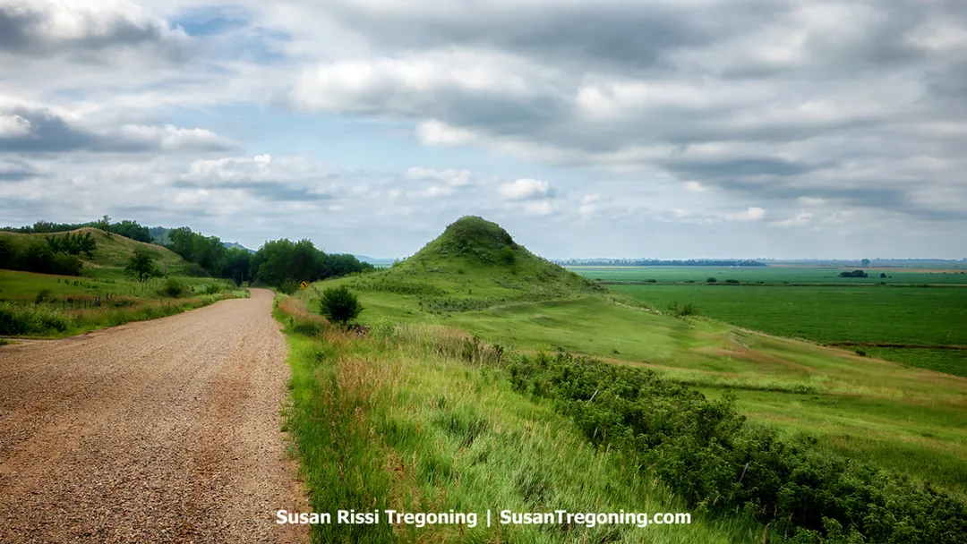 A view of Sugarloaf, a locally named hill along the Stagecoach Trail Loop. The landform rises directly from the surrounding flat farmland, standing out against the otherwise level terrain of the Loess Hills region.