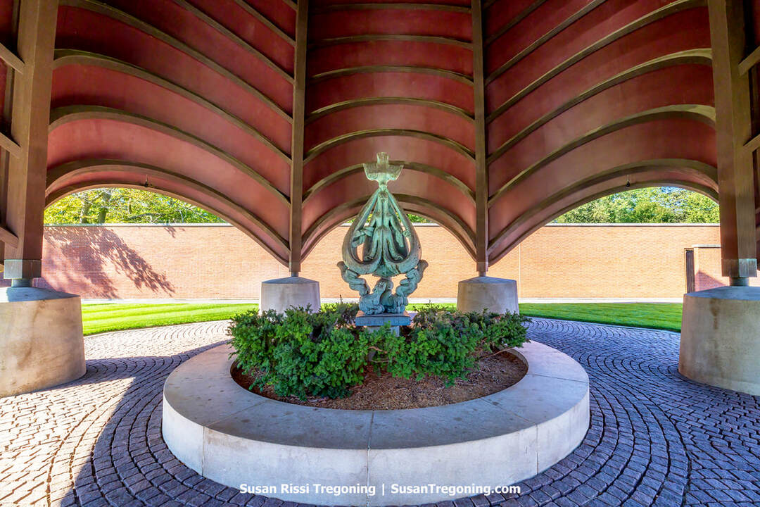 A major Cubist bronze by Jewish sculptor Jacques Lipchitz, The Descent of the Holy Spirit stands beneath the shingled, rosebud‑shaped canopy at the center of Philip Johnson’s Roofless Church in New Harmony, Indiana. The abstract, angular form rises within the open‑air sanctuary, serving as the focal artwork sheltered under the chapel’s distinctive dome.
