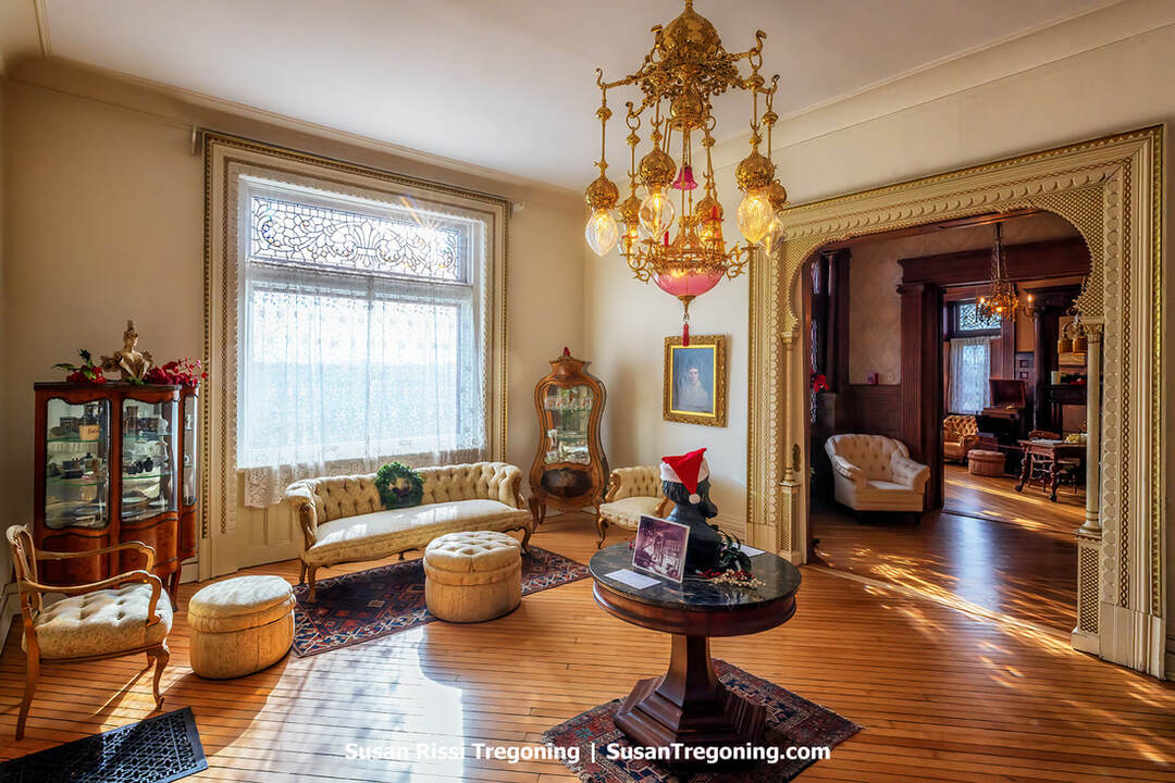 The Moorish Parlor inside the Howard Steamboat Museum features ornate woodwork, arched doorways, and richly patterned Victorian décor inspired by Middle Eastern design. Decorative columns, carved trim, and period furnishings create an opulent interior that reflects the Howard family’s taste and the craftsmanship of the steamboat‑building era.