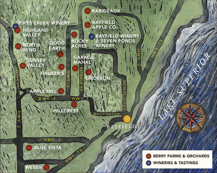   
A stylized illustrated map of the Bayfield area shows berry farms, orchards, and wineries marked with colored dots. Red dots indicate berry farms and orchards, and blue dots indicate wineries and tasting rooms. Roads labeled “HWY J,” “HWY 13,” “Washington,” and “Pike’s Creek Rd” run through the map. A compass rose appears near Lake Superior on the right side. Locations such as Weber, Blue Vista, Hillcrest, Apple Hill, Hauser’s, Good Earth, Highland Valley, North Wind, Sunset Valley, Garage Mahal, Rocky Acres, Bayfield Winery & Seven Ponds Winery, Bayfield Apple Co, Rabideaux, Pikes Creek Winery, and Erickson are marked.