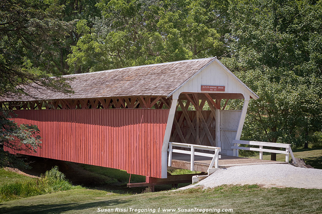 Cutler-Donahoe Covered Bridge built in 1870 currently resides in the Winterset County Park. Covered Bridges are often named for the nearby resident. Both the Cutler and the Donahoe families each claimed naming rights, thus the bridges hyphenated name. Copyright 2017 Susan Rissi Tregoning