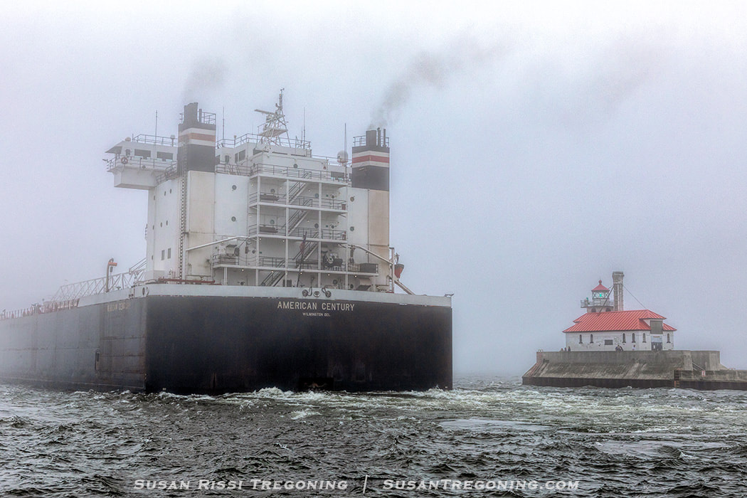 Saying goodbye to the American Century as she slips past the South Breakwater Outer Light at the end of the Duluth Ship Canal and disappears into the Lake Superior fog. 