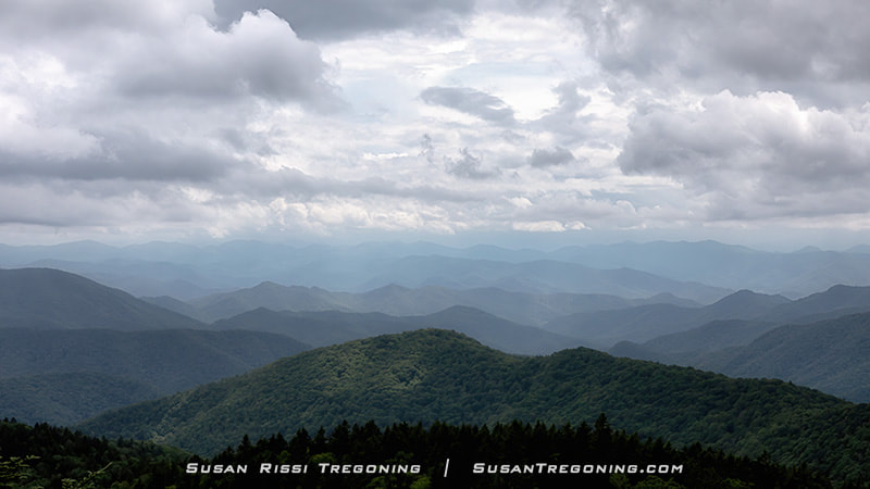 430.7 Cowee Mountain Overlook Blue ridges as far as the eye can see as the storm clouds roll in! At an elevation of 5950 feet, this overlook offers breathtaking long-range views of the Blue Ridge Mountain ridges. 
