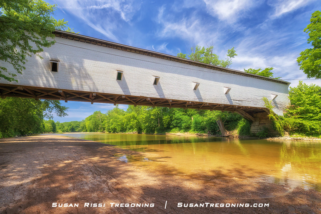 The Jackson Covered Bridge is in profile from down on Sugar Creek in Parke County, Indiana.