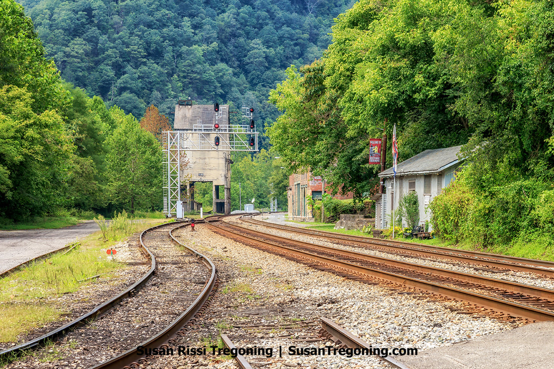 Nestled deep within the New River Gorge is Thurmond, West Virginia - a ghost town that reveals remnants of its bustling past. From a distance, one can witness the former glory of Main Street, where a labyrinth of railroad tracks took the place of roads, and the imposing Coaling Tower casts its shadow over the downtown Commercial Row.