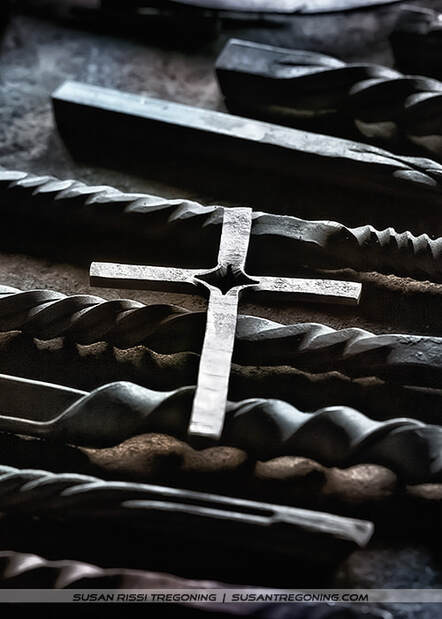 A hand forged cross in the blacksmithing area. 